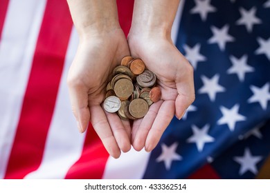 Finances, Money, Crisis, Investment And State Budget Concept - Ose Up Of Hands With Coins Over American Flag