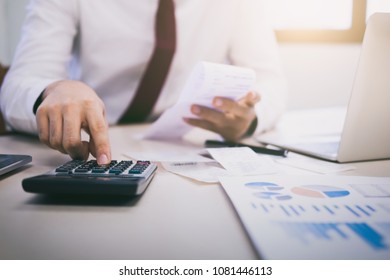 Finances Saving Economy concept. Male accountant or banker calculate the cash bill. - Shutterstock ID 1081446113