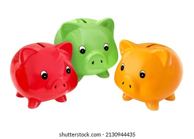 Finances and three symbolic piggy banks red green yellow  isolated against white background - Shutterstock ID 2130944435