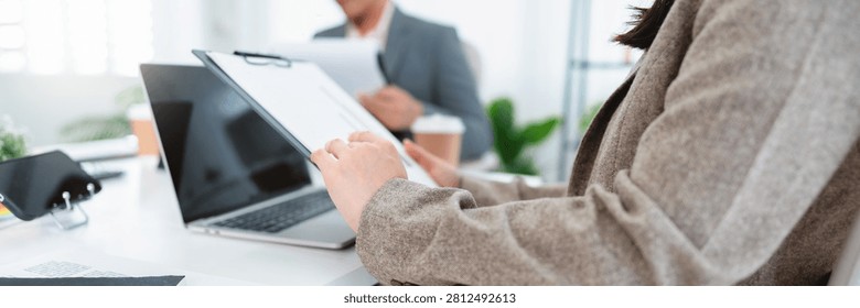 Financial admin reviewing data at worktable in professional office