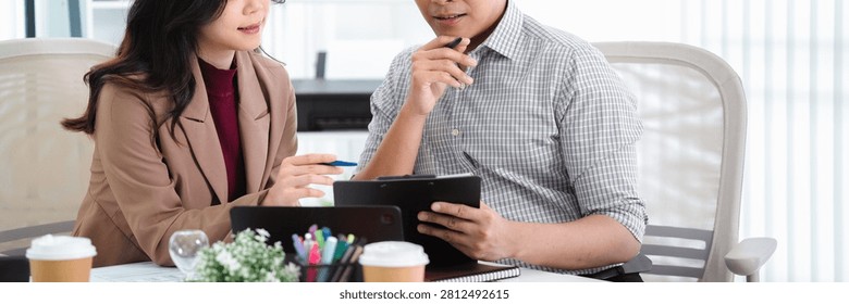 Financial admin reviewing data at worktable in professional office