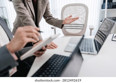 Financial admin reviewing data at worktable in professional office