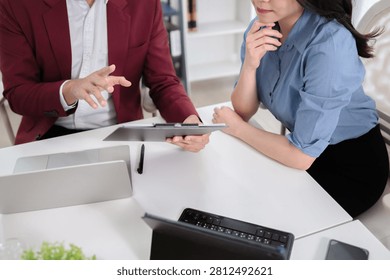 Financial admin reviewing data at worktable in professional office