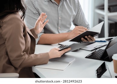 Financial admin reviewing data at worktable in professional office