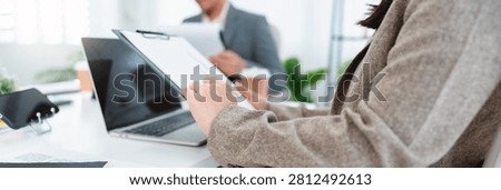 Financial admin reviewing data at worktable in professional office