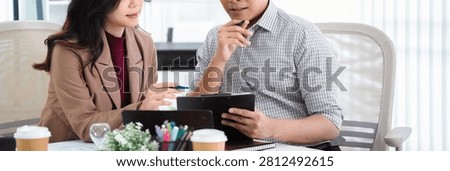 Financial admin reviewing data at worktable in professional office