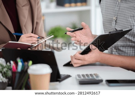 Financial admin reviewing data at worktable in professional office