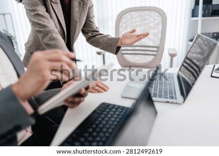 Financial admin reviewing data at worktable in professional office