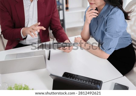 Financial admin reviewing data at worktable in professional office