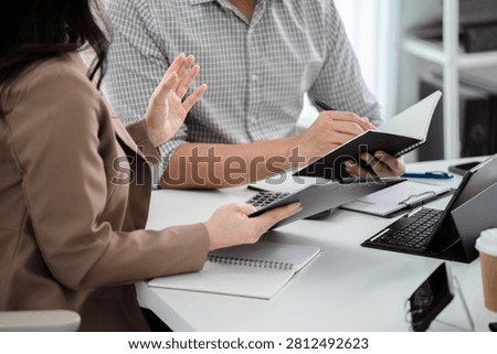 Financial admin reviewing data at worktable in professional office