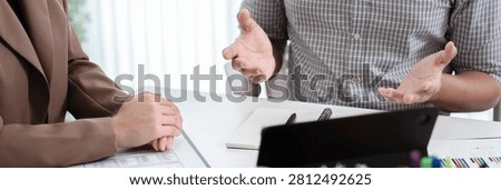 Financial admin reviewing data at worktable in professional office