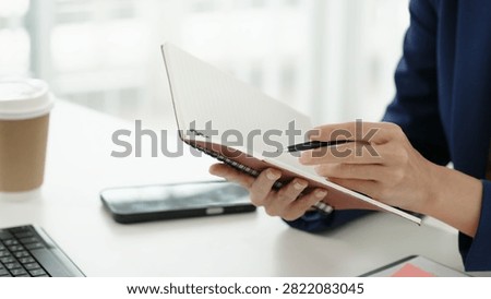 Financial admin reviewing data at worktable in professional office