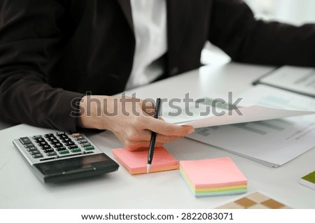 Financial admin reviewing data at worktable in professional office