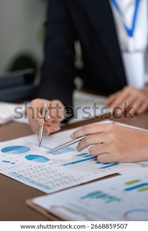 Financial advisor analyzing data with client in office setting