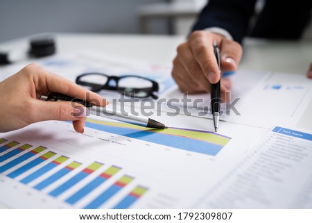 Financial Advisor Looking At Growth Progress Chart Or Graph