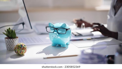 Financial Advisor With Piggybank. Money Saving Calculation