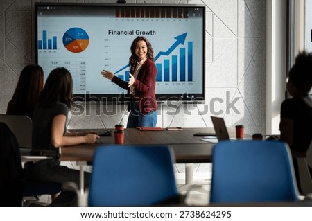 Financial advisor presenting chart data and economic analysis to colleagues in a modern office, planning future success