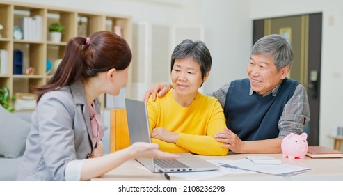 Financial Advisor Show Retirement Plan To Elderly Asian Couple By Laptop Computer At Home