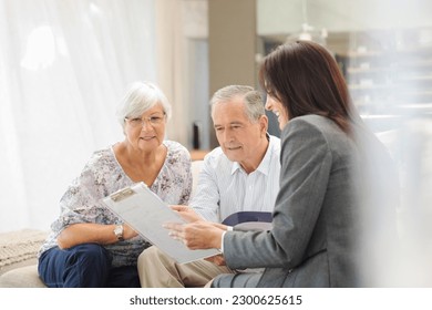 Financial advisor talking to couple on sofa - Powered by Shutterstock