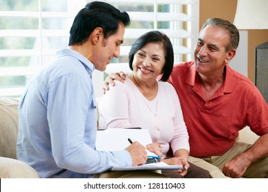 Financial Advisor Talking To Senior Couple At Home