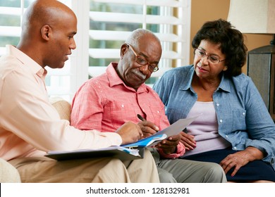 Financial Advisor Talking To Senior Couple At Home