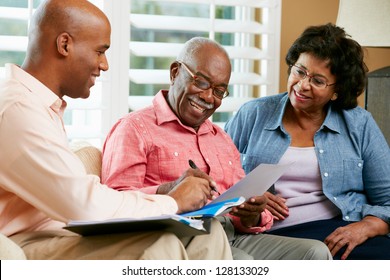 Financial Advisor Talking To Senior Couple At Home - Powered by Shutterstock