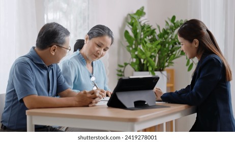 Financial advisor,realtor agent,insurance,lawyer,Manage your retirement fund concept.Financial advisor showing presentation on computer,deal shake hand to happiness Elderly asian couple retirement - Powered by Shutterstock