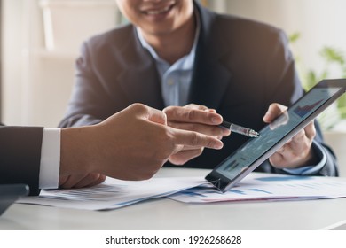 financial advisory services. Asian advisor showing plan of investment to clients in the consultancy office. - Shutterstock ID 1926268628