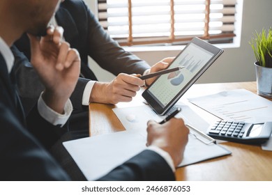 financial advisory services. Asian advisor showing plan of investment to clients in the consultancy office. - Powered by Shutterstock