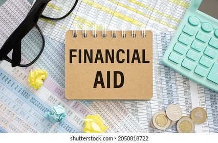 Financial Aid - Text Written On A Notebook With Office Background