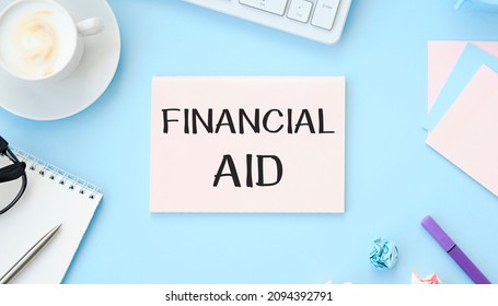 Financial Aid - Text Written On A Notebook With Office Background