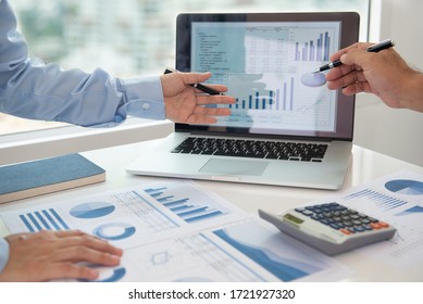 Financial analyst analysis business financial report on digital tablet during discussion at meeting of corporate showing the results of their successful teamwork. - Shutterstock ID 1721927320
