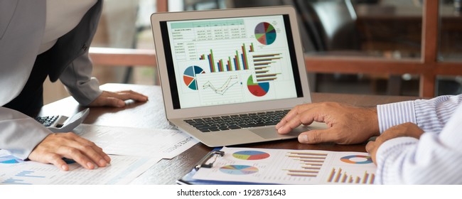 Financial analyst analysis business financial report on digital tablet during discussion at meeting of corporate showing the results of their successful teamwork. - Powered by Shutterstock