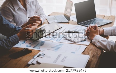 Financial analyst analysis business financial report on digital tablet during discussion at meeting of corporate showing the results of their successful teamwork, business meeting concept, Marketing
