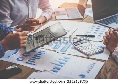 Financial analyst analysis business financial report on digital tablet during discussion at meeting of corporate showing the results of their successful teamwork, business meeting concept, Marketing
