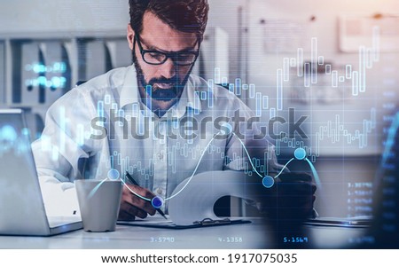 A financial analyst in glasses is making notes and trying to settle a new approach to deal with clients needs to boost the business and achieve exceptional financial results. Double exposure.