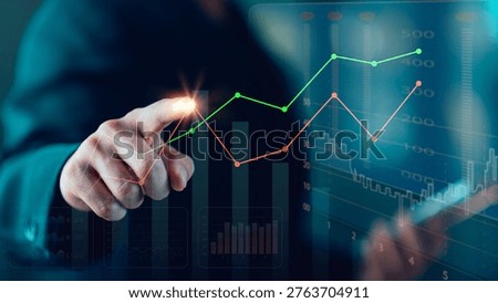 A financial analyst uses digital data charts to track business performance, investment growth, and market trends, showcasing modern analytics, strategic planning, and financial technology insights.