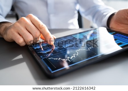 Financial Analyst Using Analytics Technology On Tablet