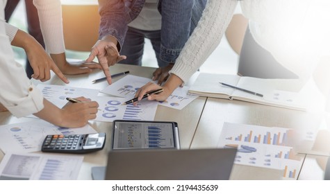 Financial Analysts Analyze Business Financial Reports On A Digital Tablet Planning Investment Project During A Discussion At A Meeting Of Corporate Showing The Results Of Their Successful Teamwork.