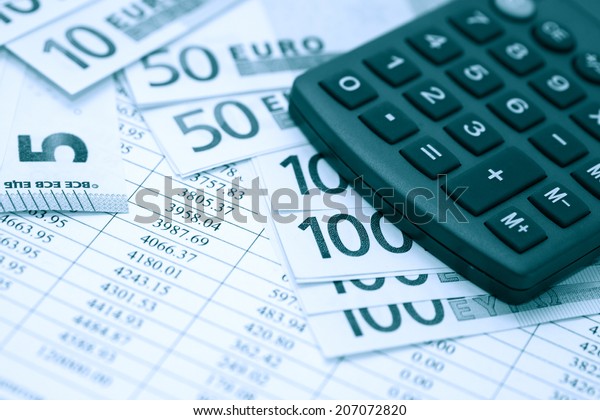Financial background.\
European Union Currency near calculator on paper background with\
digits table