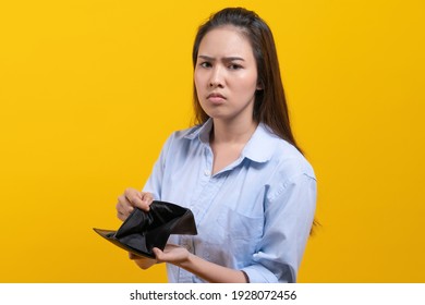 Financial Bankruptcy Young Girl Opening Empty Wallet And Worrying Face Isolated On Yellow Background.