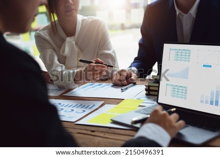 financial, Brainstorming, Consulting, Data Analysis, Planning, Marketing and Accounting, Economist pointing to investment documents with partners on profit taking to compete with other companies