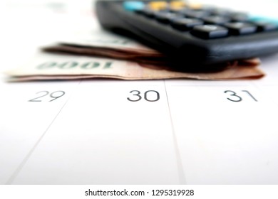 Financial Budget / Payment On Pay Day At The End Of The Month - With Calculator ,cash Money And Calendar On White Background.