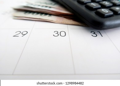 Financial Budget / Payment On Pay Day At The End Of The Month - With Calculator ,cash Money And Calendar On White Background.