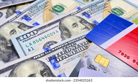 Financial business background concept. The American national currency. Credit cards are on $100 bills. Cash bills of one hundred US dollars.
