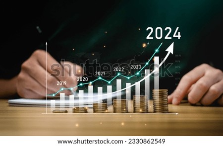 financial business growth 2024 concept. businessperson calculate income and profit on investments and an increase in the indicators of positive growth, with virtual holographic chart graph. rich, coin