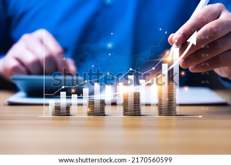 financial business growth concept. businessperson calculate income and profit on investments and an increase in the indicators of positive growth, with virtual holographic chart graph. rich, coin
