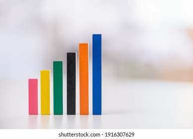 Financial Business Growth Or Sales Performance Increase Concept : Increasing Height, Color Wood Bar Graphs On A Table, Depicts Increasing Of Productivity Or Challenging Amount On Competitive Market