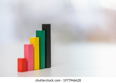 Financial Business Growth Or Sales Performance Increase Concept : Increasing Height, Color Wood Bar Graphs On A Table, Depicts Increasing Of Productivity Or Challenging Amount On Competitive Market