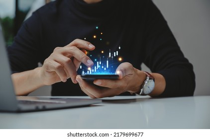 Financial and business investment concept. Businessman using smartphone analyze investment in stock market. growth graph chart on screen.  - Powered by Shutterstock